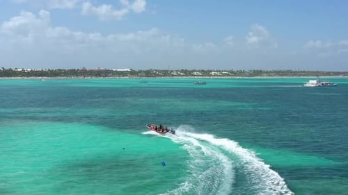 People Having Fun Riding Speedboat in Azure Caribbean Sea