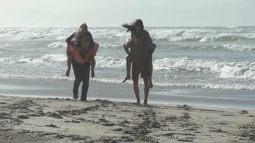 Friends Piggyback on Beach Vacation