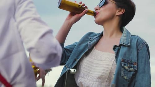 Beautiful Woman Drinking Beer And Dancing At Party Outdoors