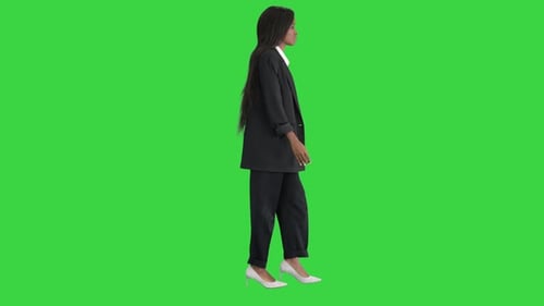 Casual African American Businesswoman Walking on a Green Screen, Chroma Key.