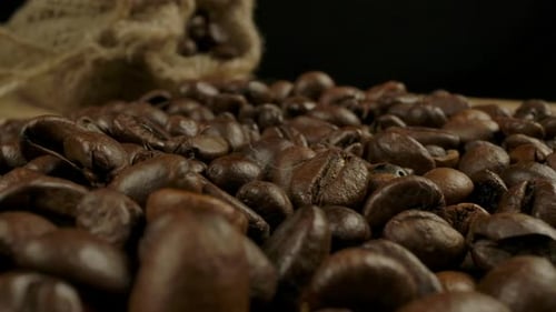 Macro View of Roasted Coffee Beans and Jute Sack