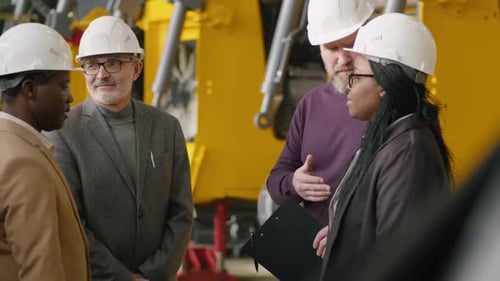 Factory Engineers and Managers Shaking Hands and Discussing Business
