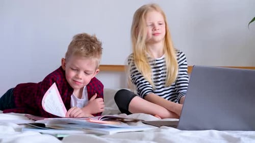 Siblings Study Together at Home