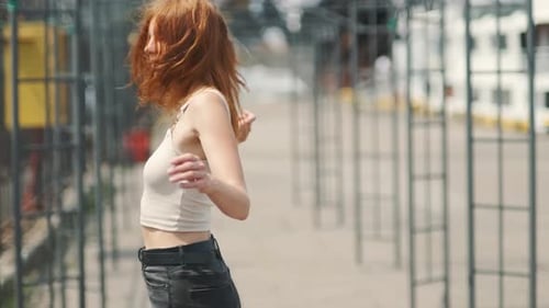 Portrait of Beautiful Smiling Redhaired Woman on Street at Day