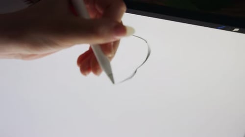 Close up of a digital pen drawing artwork on a graphic tablet