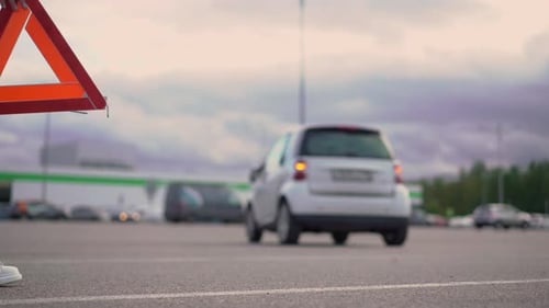 Roadside Hazard Triangle Sign Next to White Vehicle