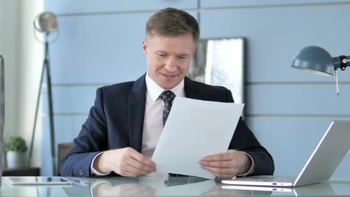 Happy Business Man Celebrates Reading Good News