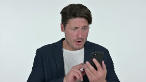 Man Looks at Phone with Surprised Expression