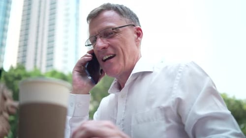 Man Talking on Cell Phone Outside in City