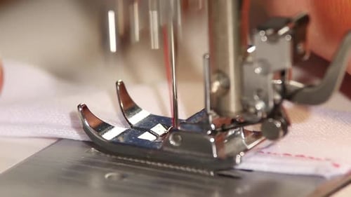 Sewing Machine Stitching Fabric with Red Thread Close Up