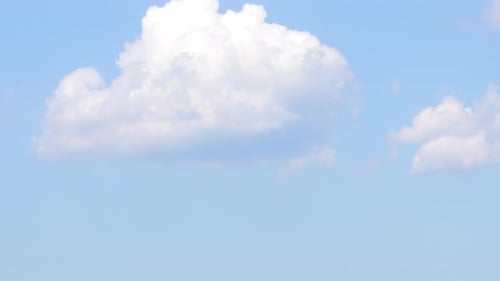 Fluffy Clouds Drifting across the Blue Sky