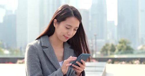 Business woman work on mobile phone at outdoor