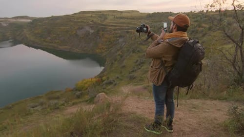 Tourist Taking Photos of Scenic View at Sunset