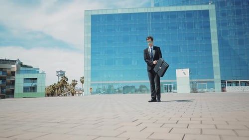 Flexible and cool businessman doing acrobatic tricks outdoor.