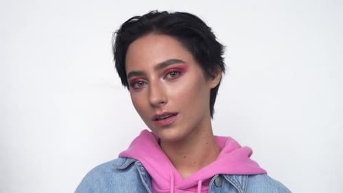 Young Woman Posing with Bright Eye Shadow
