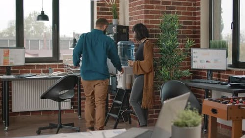 Colleagues Chatting by the Water Cooler in Office
