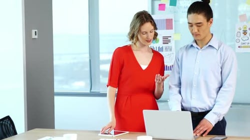 Business Professionals Reviewing Data in Modern Office