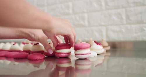 Baker Hands Assembling Delicious Pink Macarons