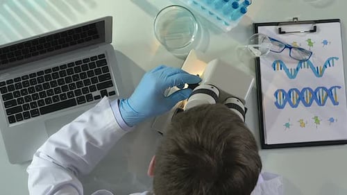 Research Lab Employee Conducting Tests and Inserting Their Results in Computer