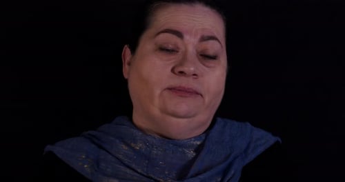 Close Up of Woman Speaking on Black Background