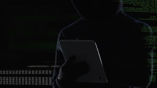 Hacker Using Tablet in Dark Futuristic Setting