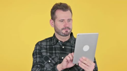 Portrait of Attractive Middle Aged Man Using Tablet in Office