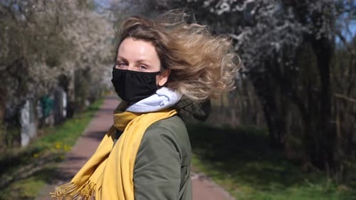 Portrait Of Beautiful Woman Wearing Mask Walking On Street In Spring