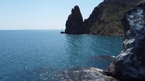 Aerial View From Above on Azure Sea and Volcanic Rocky Shores