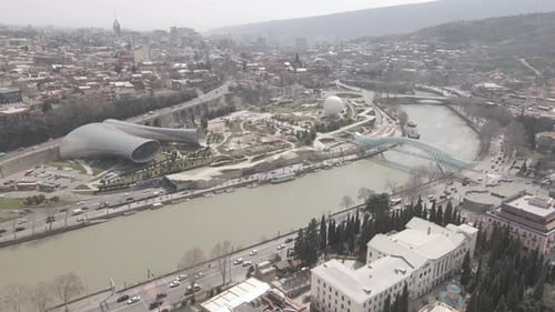 Aerial view of Tbilisi city central park and Bridge of Peace. Beautiful cityscape of old Tbilisi