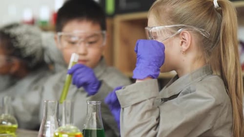 Children in Lab Coats Mixing Chemicals