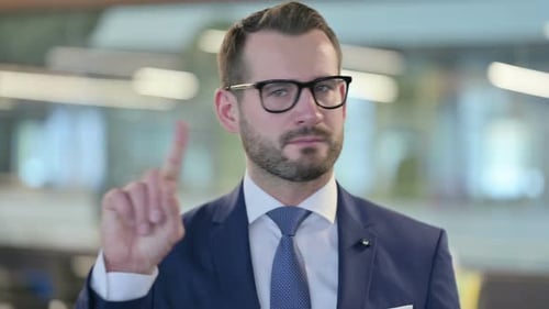 Portrait of No Sign By Middle Aged Businessman By Finger Gesture