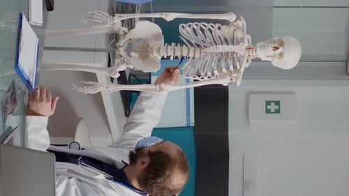 Doctor Explains Anatomy Using Medical Skeleton in Hospital
