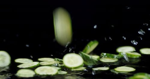 Cucumber Slices Fall on the Water Splashes.