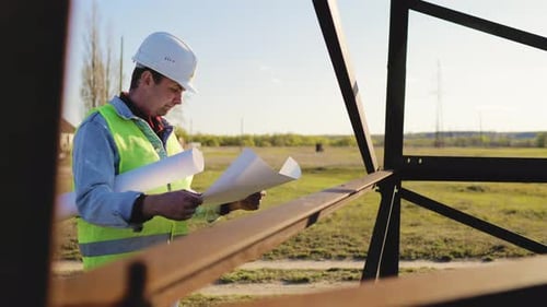 Architect Worker Checking Construction Project On Electric Tower