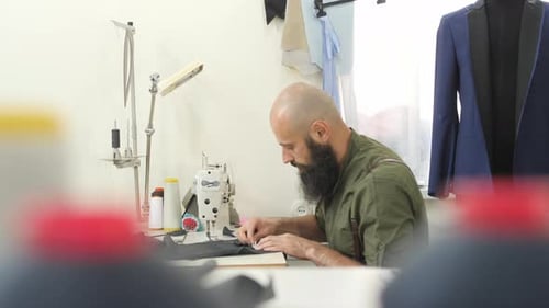 Man Tailor Sewing at Sewing Machine
