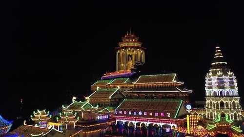 Drone shot to reveal the the Kuan Yin pavilion at Kek Lok Si temple at night.