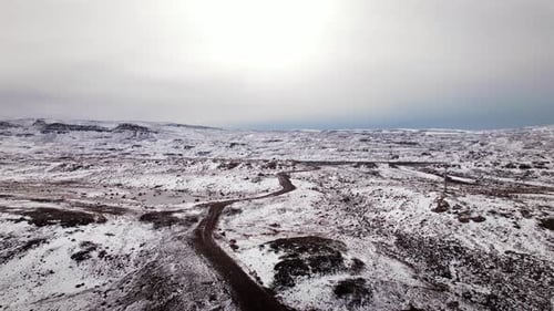 Winter Aerial View of Snowy Road to Lake