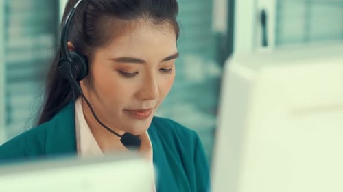 Geschäftsfrau mit Headset arbeitet aktiv im Büro