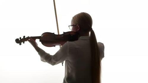 Blonde Woman Plays Violin in Bright Light