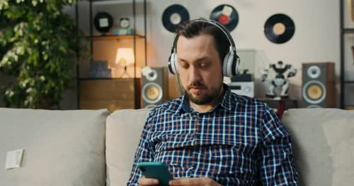 Man Listening to Music on Headphones at Home