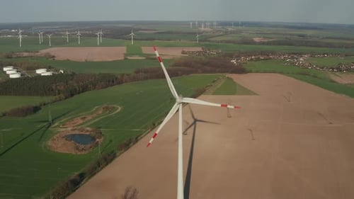 AERIAL: Close Up Shot of Wind Turbine, Mill Rotating By the Force of the Wind Generating Renewable
