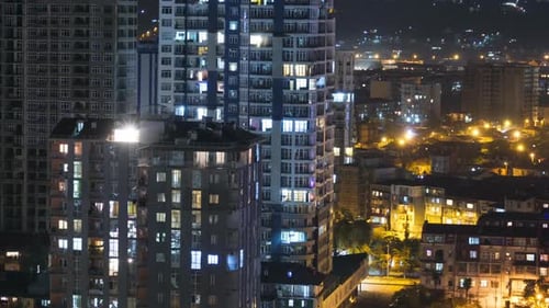Multistorey Buildings with Changing Window Lighting At Night in City. Timelapse