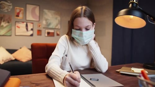 Students Return to School After COVID 19 Coronavirus Lockdown Kid Wearing a Mask Doing Homework on