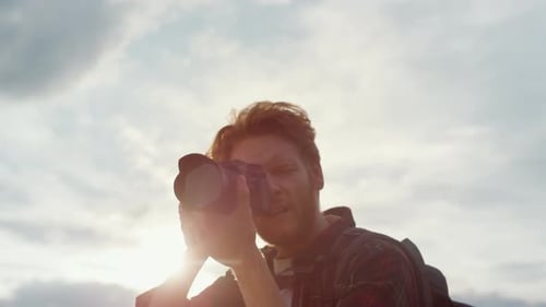 Auburn Haired Man Taking Photos on Outdoor Adventure