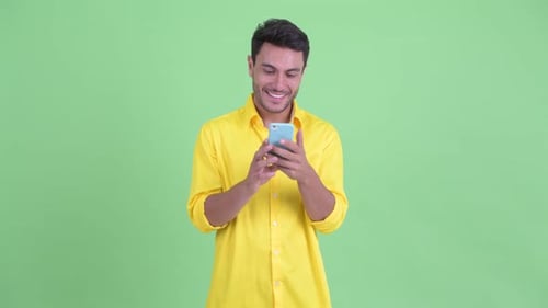 Smiling Man Using Phone in Studio
