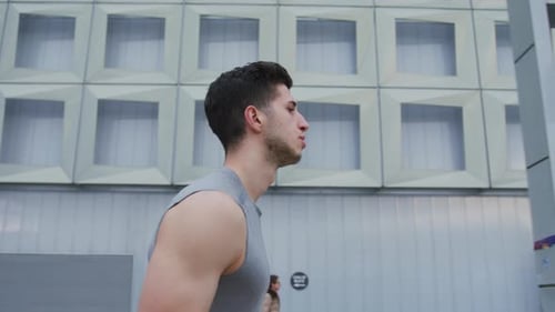 Fit Young Adult Runs Through City Streets