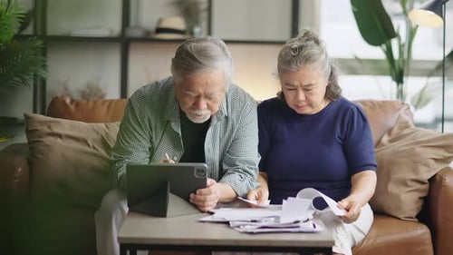 Senior Couple Reviewing Bills at Home