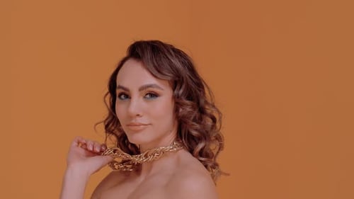 Woman Posing with a Gold Chain Necklace