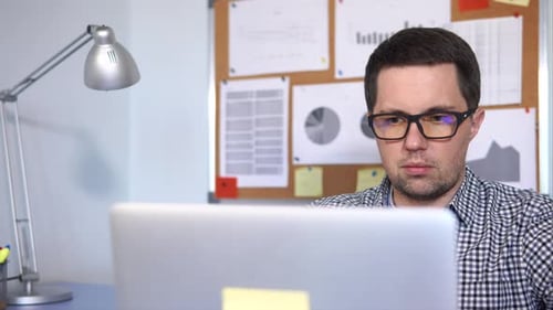 Close Up Shot of a Man's Face Who Works As a System Administrator in the Office