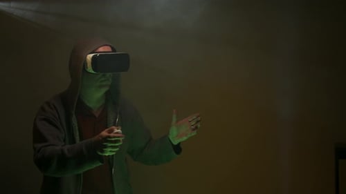 Man Using Virtual Reality Headset in Dark Room